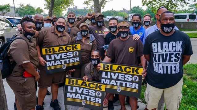 crowd of workers, many in brown UPS uniforms, with "Black Lives Matter" signs