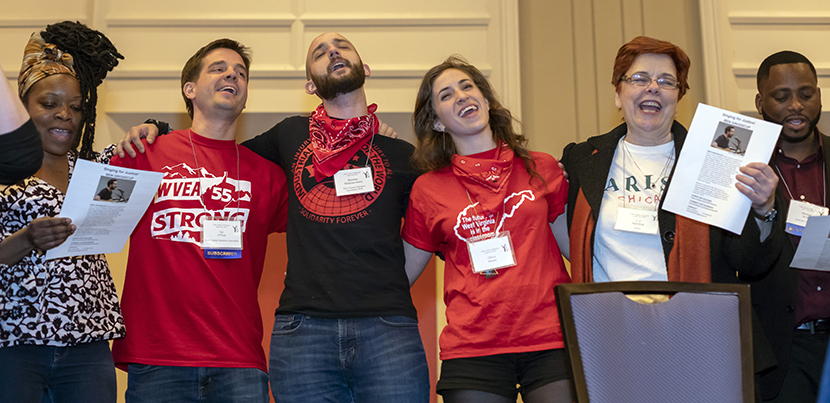 Group of singers in line, with arms around each other, at 2018 Labor Notes Conference.