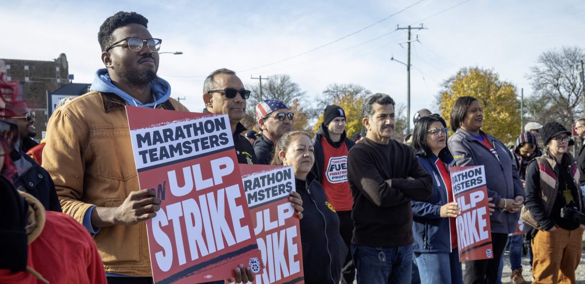 Striking workers and supporters hold signs that say Marathon Teamsters on ULP strike at a rally.