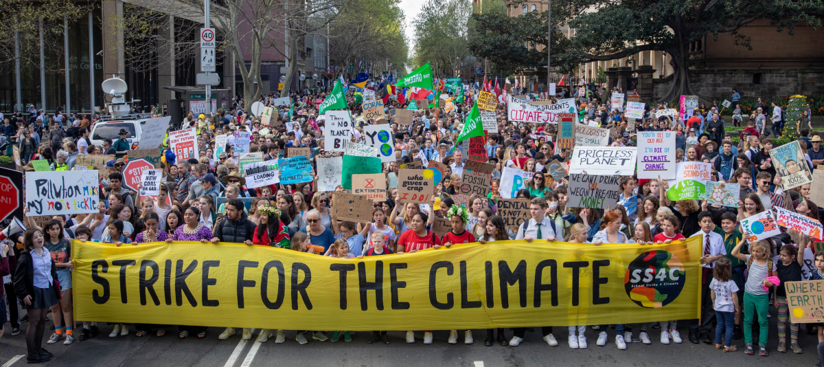 huge crowd of people, front row carries "global strike for the climate" banner