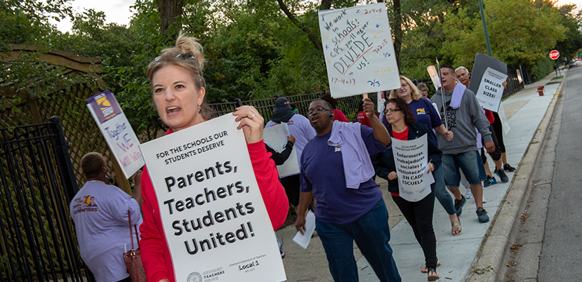 Chicago teachers and Service Employees (SEIU) Local 73 marching with signs.