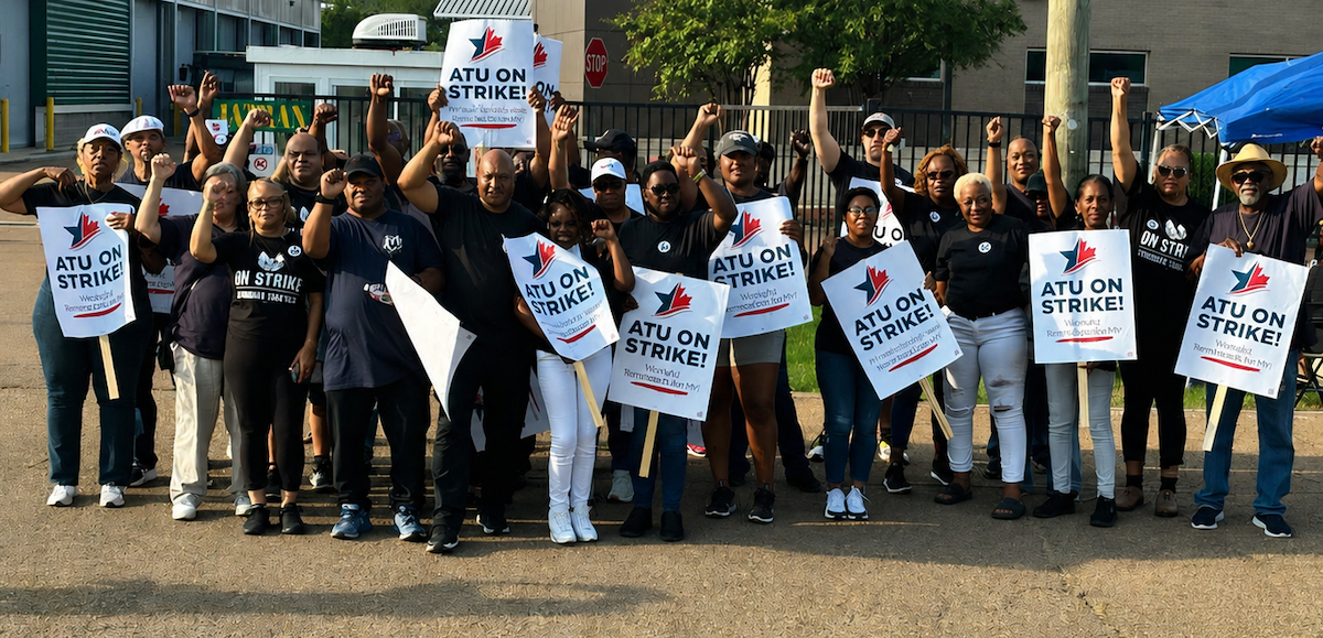 Thirty Black workers stand with signs saying “ATU on Strike”
