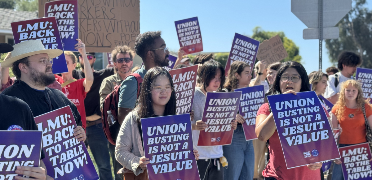 Students and faculty members rally holding signs that say "Union Busting Is Not a Jesuit Value" and "LMU: Back to the Table Now."