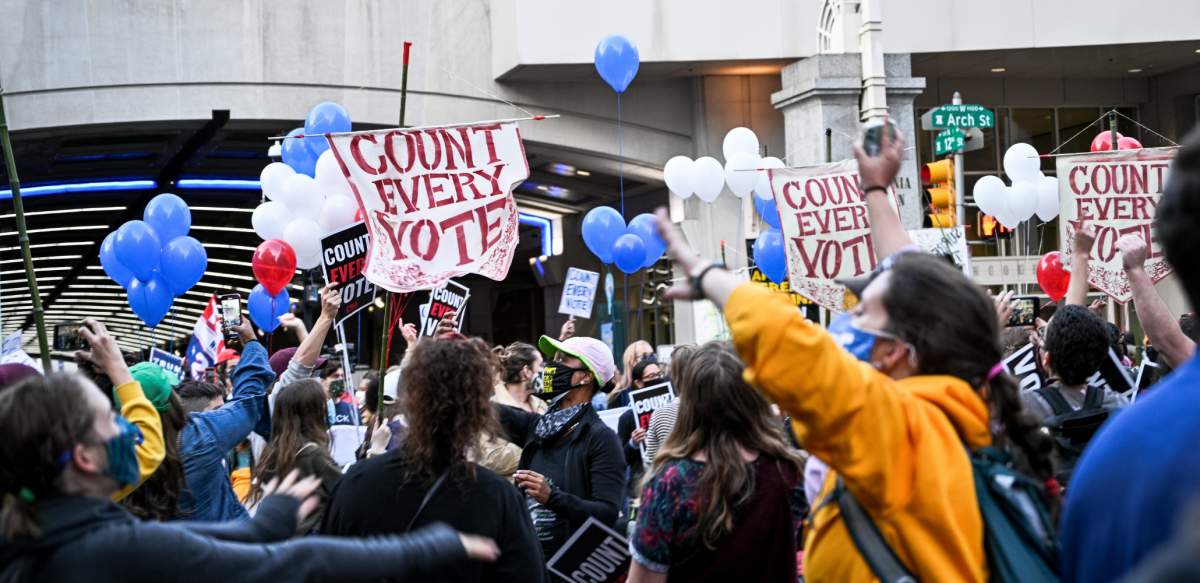 Crowd with many "count every vote" signs and balloons