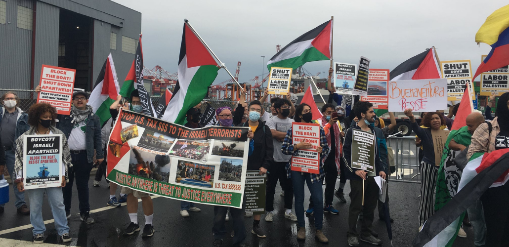 Block the Boat NY/NJ protesters with Palestinian flags at the port near Elizabeth, NJ.