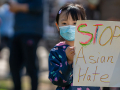 Little girl holding sign reading "Stop Asian Hate."