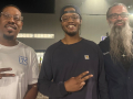 Three workers who served as election observers for the union pose for a photo, with their hands giving peace signs.