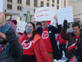 A crowd marches with signs