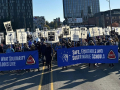 A large crowd in blue marches with banners. One says, “Safe, equitable and sustainable schools” and many carry “ready to strike” signs.