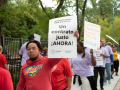 A CTU member holds a sign reading: "Fair contract now!" in Spanish