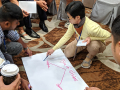 Workshop participants at the Labor Notes Asia Regional Conference discussing and writing about strikes.