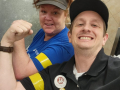 A man and a woman hold up fists
