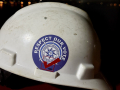A white hardhat with a sticker that reads "Respect Our Vote."