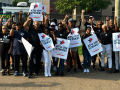 Thirty Black workers stand with signs saying “ATU on Strike”