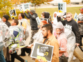 Amazon workers march holding signs that say higher wages. 